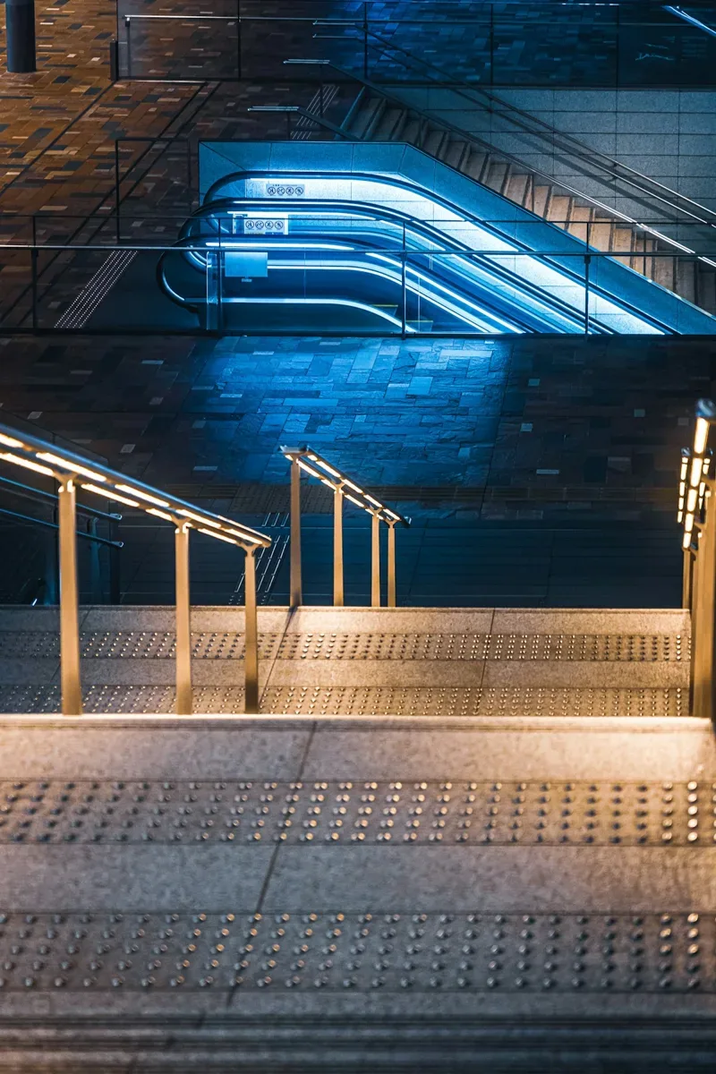 Exterior entrance steps with a series of illuminated handrails